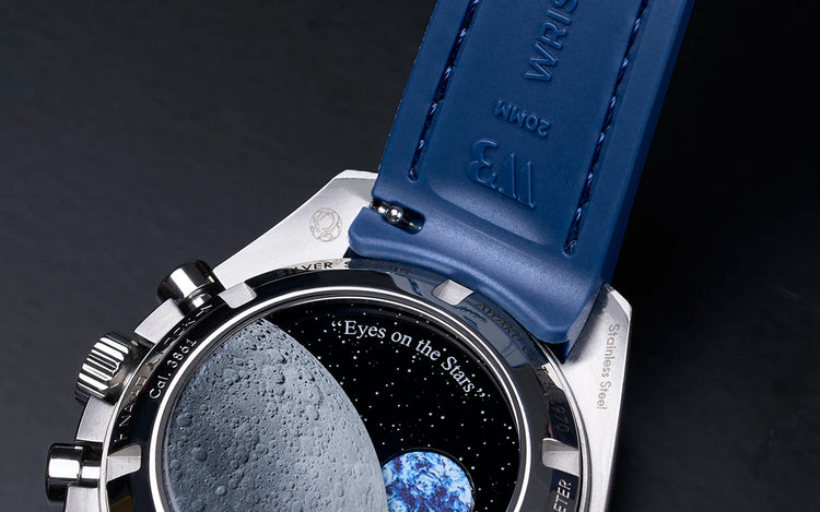 Close-up of blue Wristbuddys Vertech rubber strap attached to Omega Speedmaster Snoopy highlighting Wristbuddys quick release spring bar system