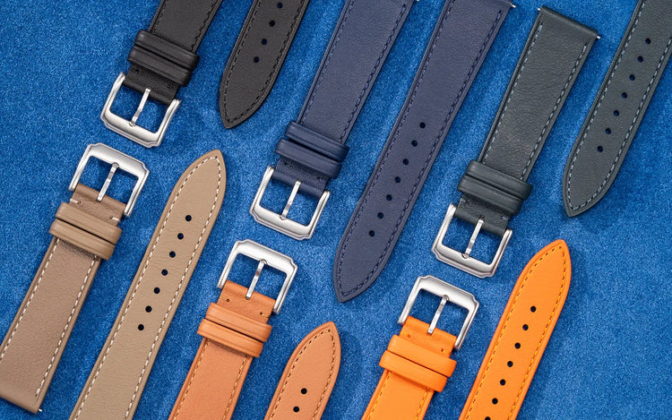 Leather watch straps in different colors displayed on a blue background, crafted by Wristbuddys.