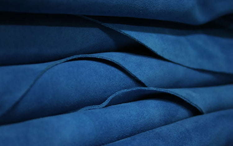 Close up of blue suede leather hides used in the first step of Wristbuddys leather crafting process.