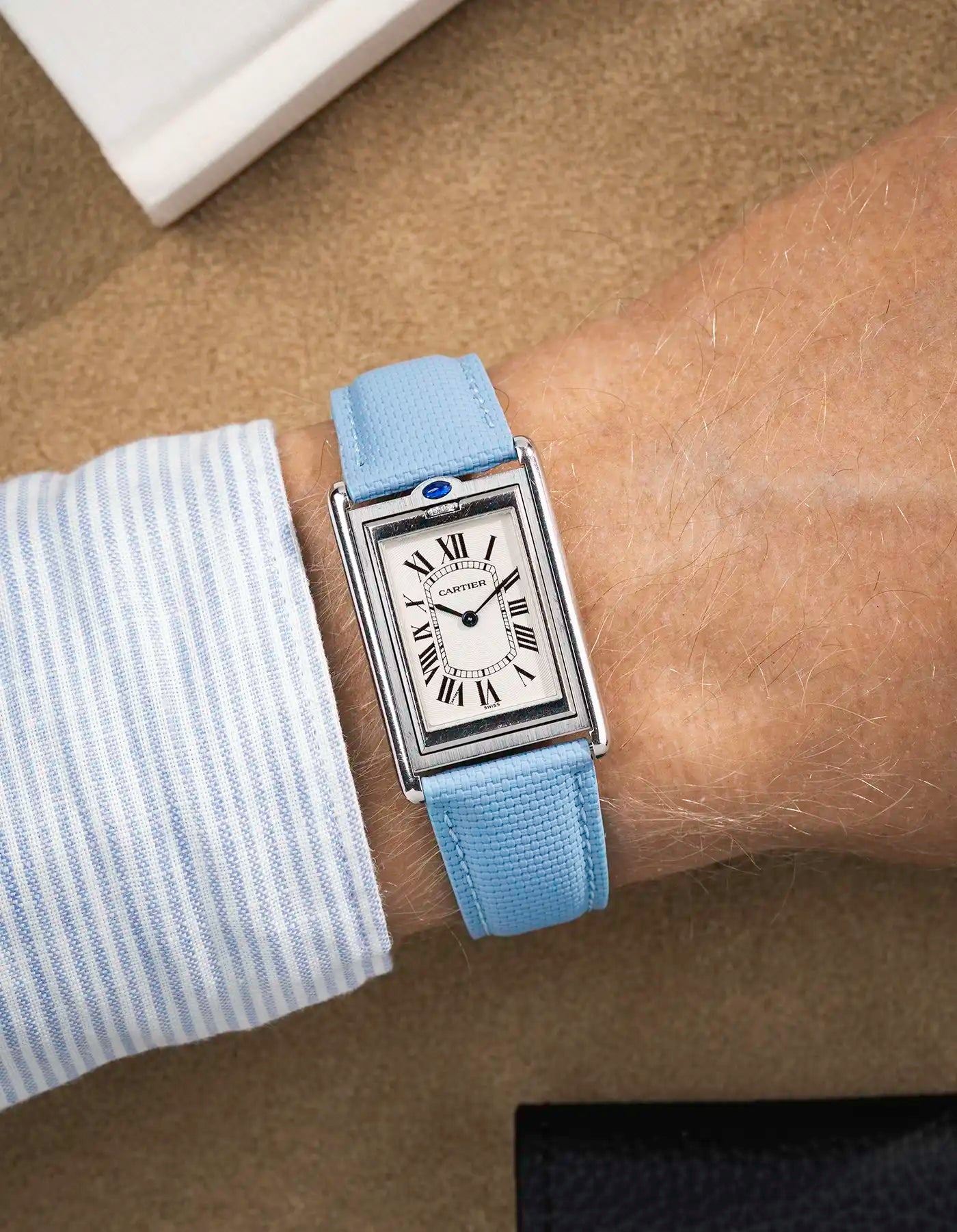 Light blue sailcloth strap fitted on Cartier Tank Louis with white dial – elegant wrist shot