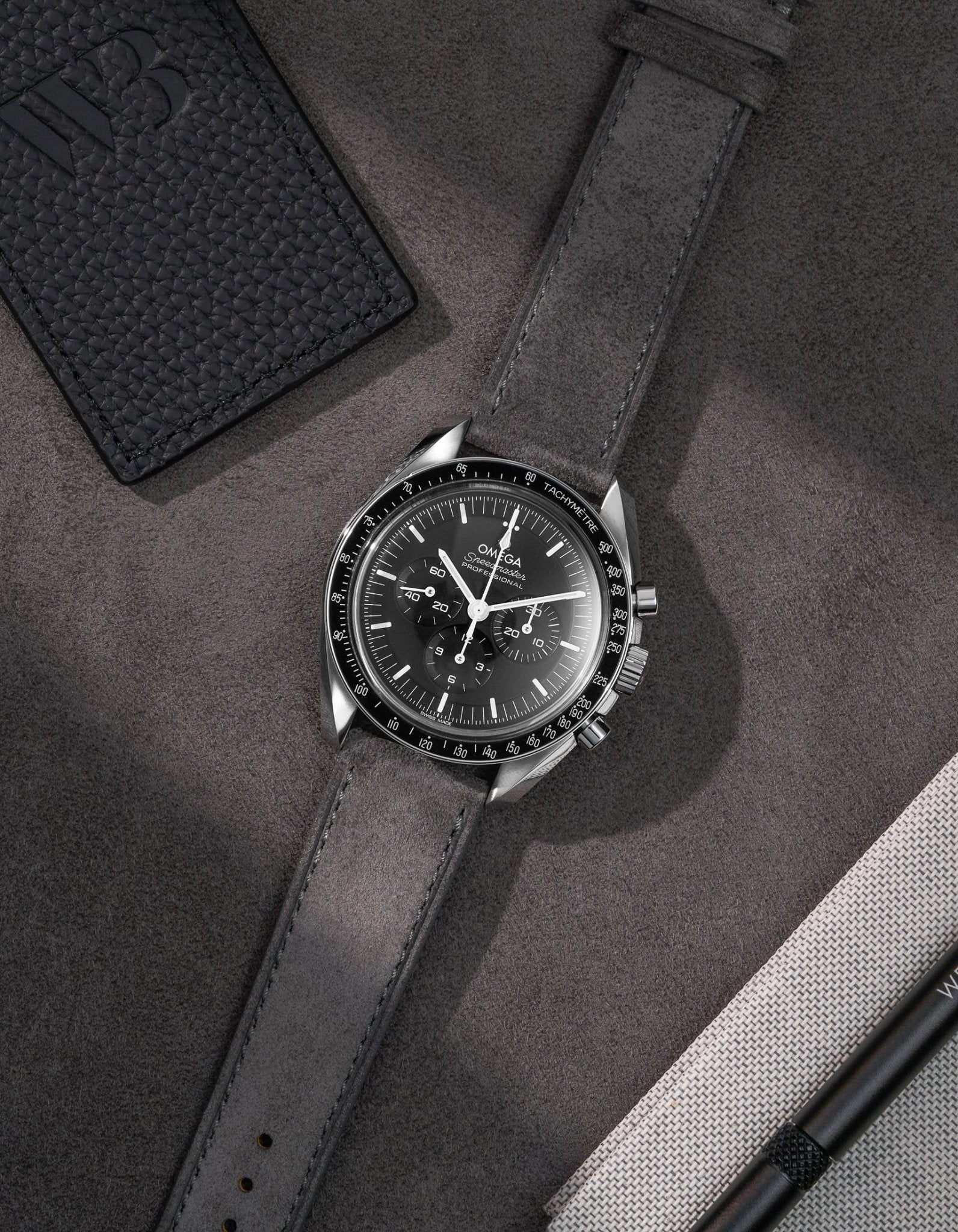 Light Grey Suede Leather Strap  17mm - 21mm on Speedmaster flat lay on grey background
