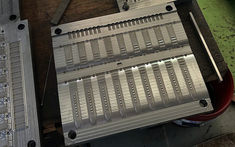 High-precision aluminum mold used in Wristbuddys rubber watch strap manufacturing process for consistent shaping