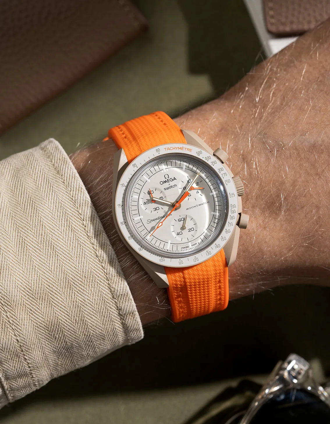 Curved rubber strap for MoonSwatch Mission to Jupiter – orange band designed specifically for the Jupiter model, shown on wrist