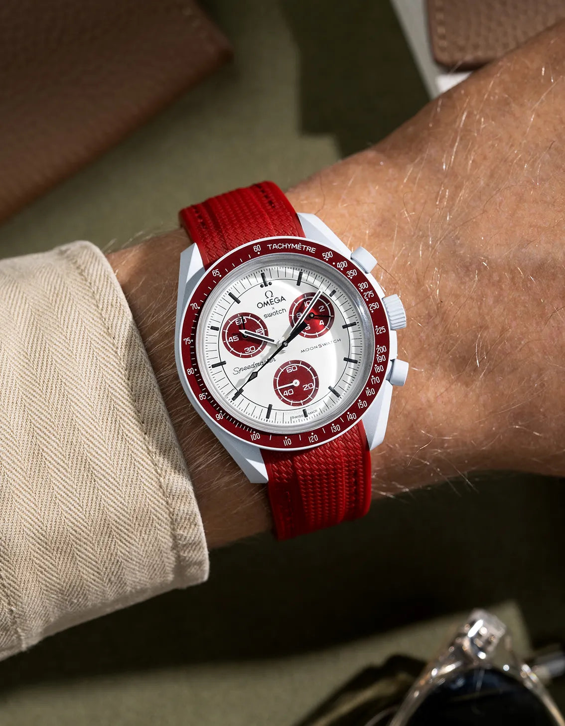 Burgundy rubber strap for MoonSwatch Mission to Pluto – shown on wrist