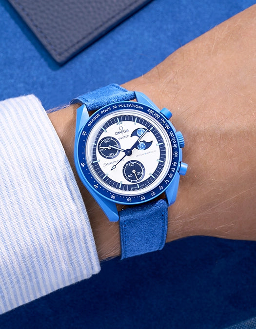 Omega X Swatch Mission to Super Blue Moonphase with Ocean Blue suede leather strap worn on wrist – styled shot