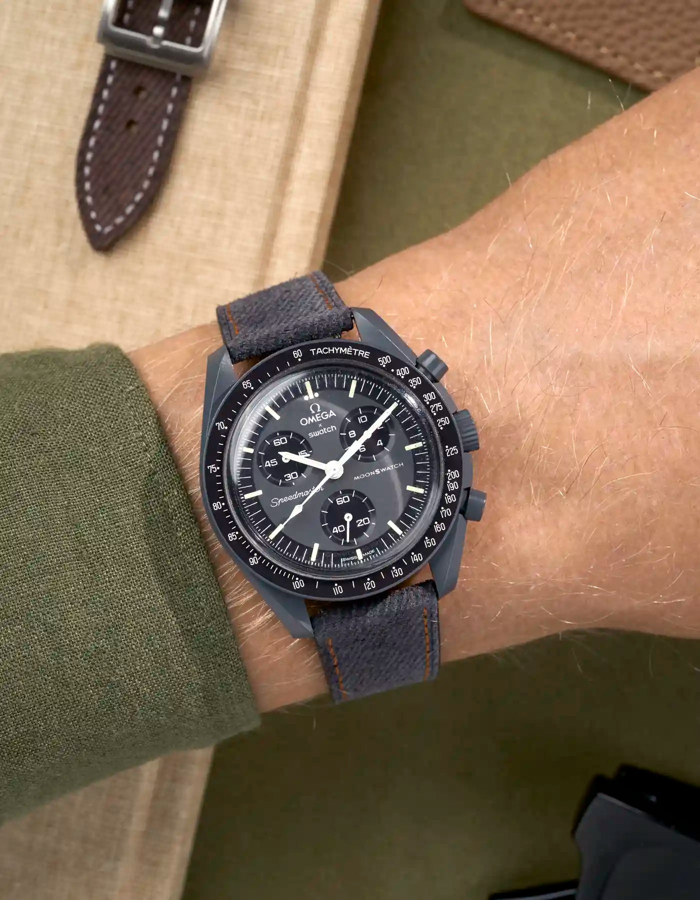 Wrist shot of Omega X Swatch Mission to Mercury with Dark Grey & Orange Stitch Denim Strap – denim texture detail
