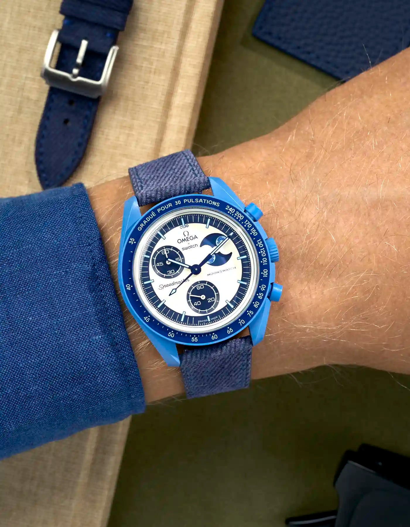 Omega X Swatch Mission to Super Blue Moonphase on blue denim strap with matching blue stitching – wrist shot