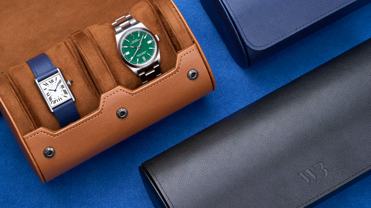 Leather watch rolls in brown, navy, and black displayed with luxury watches, representing Wristbuddys collection of premium watch rolls.