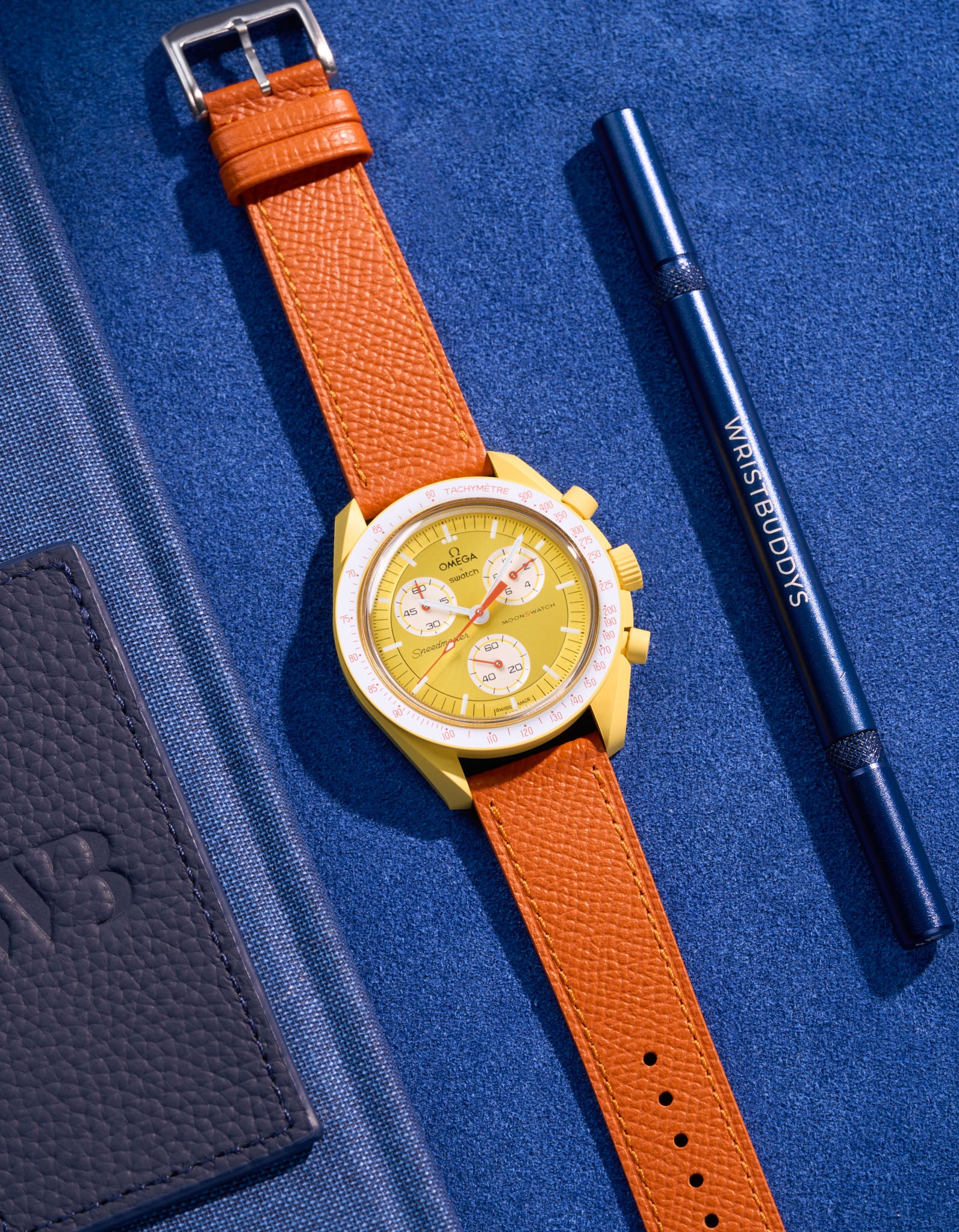 Flat lay of Orange Epsom leather strap for Omega x Swatch MoonSwatch Mission to the Sun