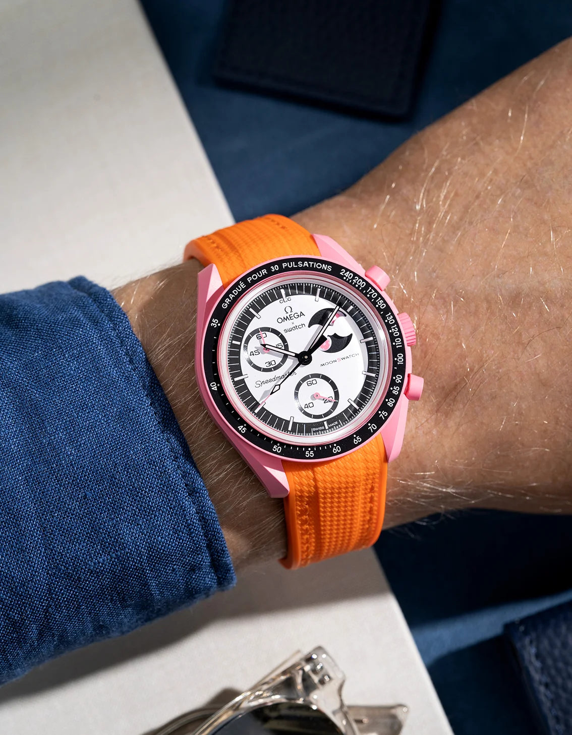 Wrist shot showing orange rubber strap for Omega X Swatch MoonSwatch Mission to the Pink Moonphase