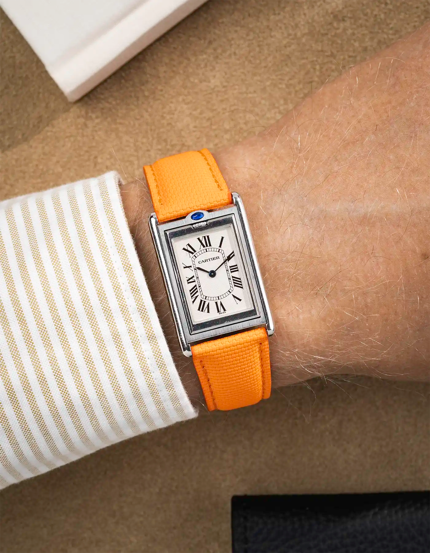 orange rubberised sailcloth strap on wrist with white dial – part of collection overview