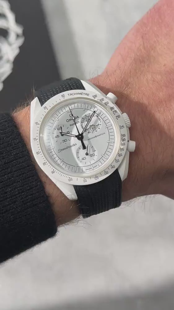 Short UGC clip showing a wrist roll of a MoonSwatch Mission to The Moonphase with a black rubber strap 