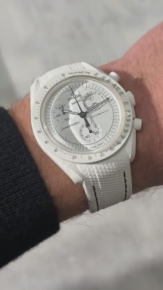 Short UGC clip showing a wrist roll of a MoonSwatch Mission to The Moonphase with a white and black rubber strap 