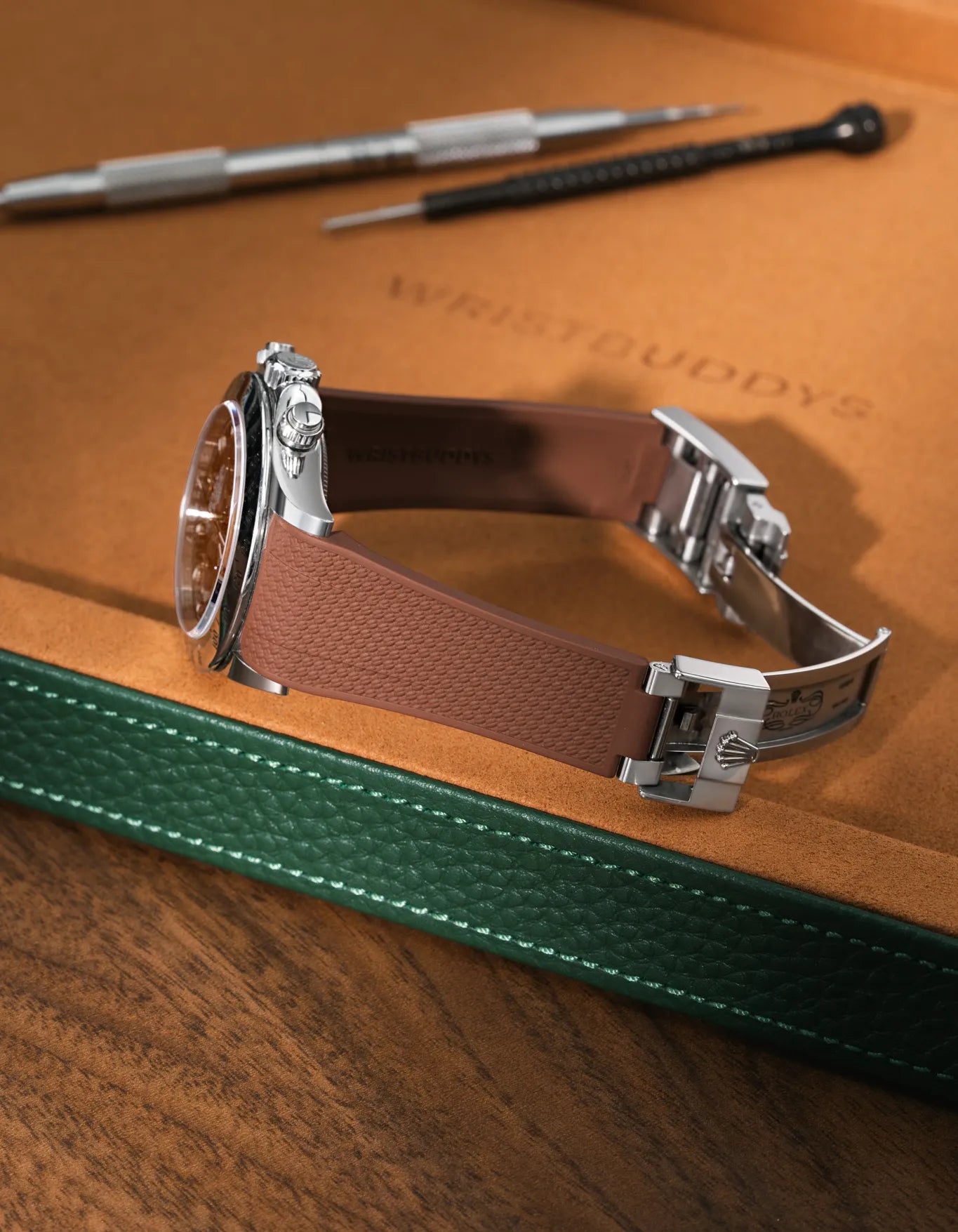 Brown Vertech-surface FKM rubber strap for Rolex Daytona 116520, premium integrated design for original clasp, resting on a brown leather tray.