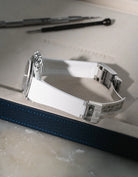 White Vertech FKM rubber strap for Rolex Daytona 116520, custom integrated fit with original steel clasp, resting on a white valet tray.