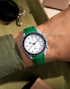 Green curved-end rubber strap made for MoonSwatch 1965, shown on wrist with signature Vertech texture