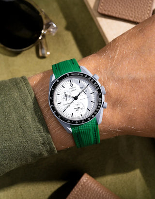 Green curved-end rubber strap made for MoonSwatch 1965, shown on wrist with signature Vertech texture