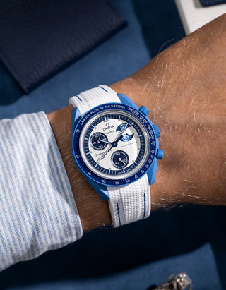 Wrist shot of white rubber strap with blue stitching for MoonSwatch, photographed on the Mission to the Super Blue Moonphase