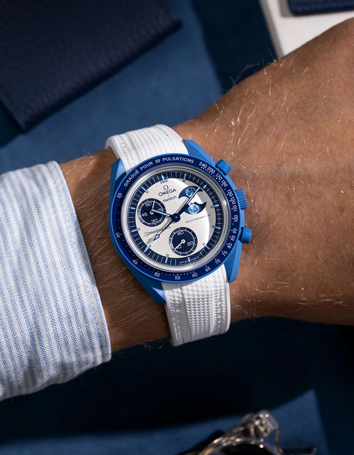 Wrist shot of white curved vertech rubber strap for MoonSwatch, photographed on the Mission to the Super Blue Moonphase