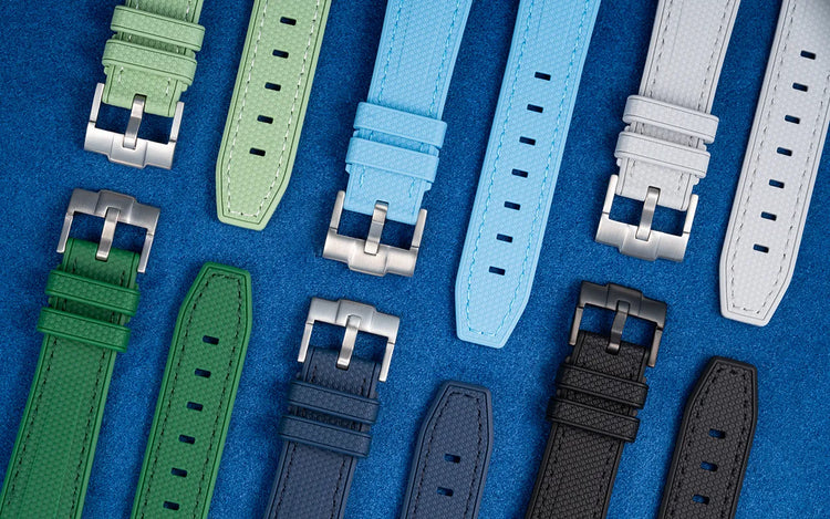 Colorful selection of Wristbuddys rubber watch straps displayed on blue background to showcase fit, design, and variety