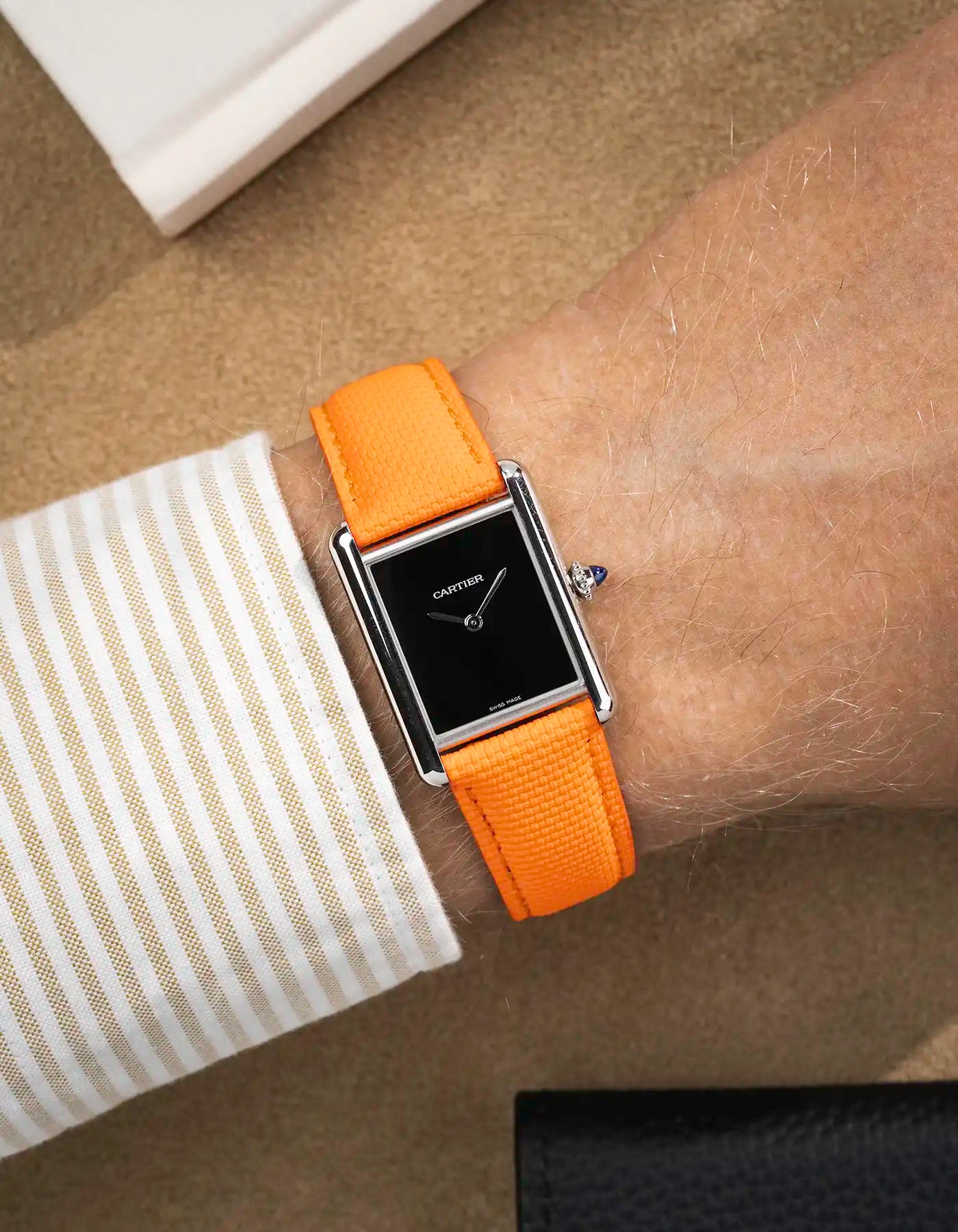 orange rubberised sailcloth leather strap shown on wrist – black dial version for collection view