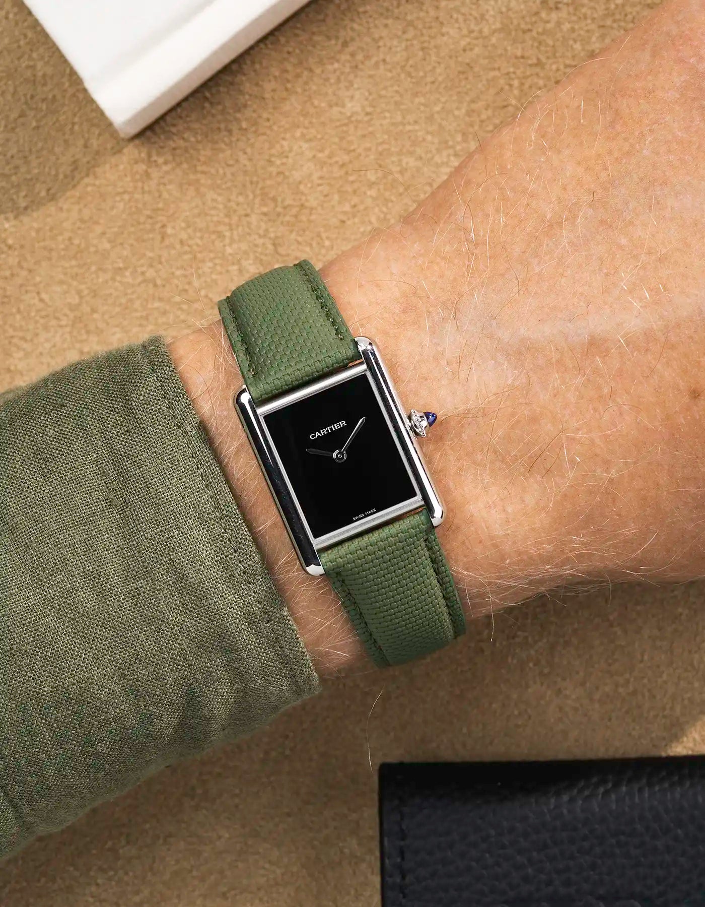 Rubberised sailcloth leather watch strap on Cartier Tank Must with black dial – dressed wrist shot with soft texture