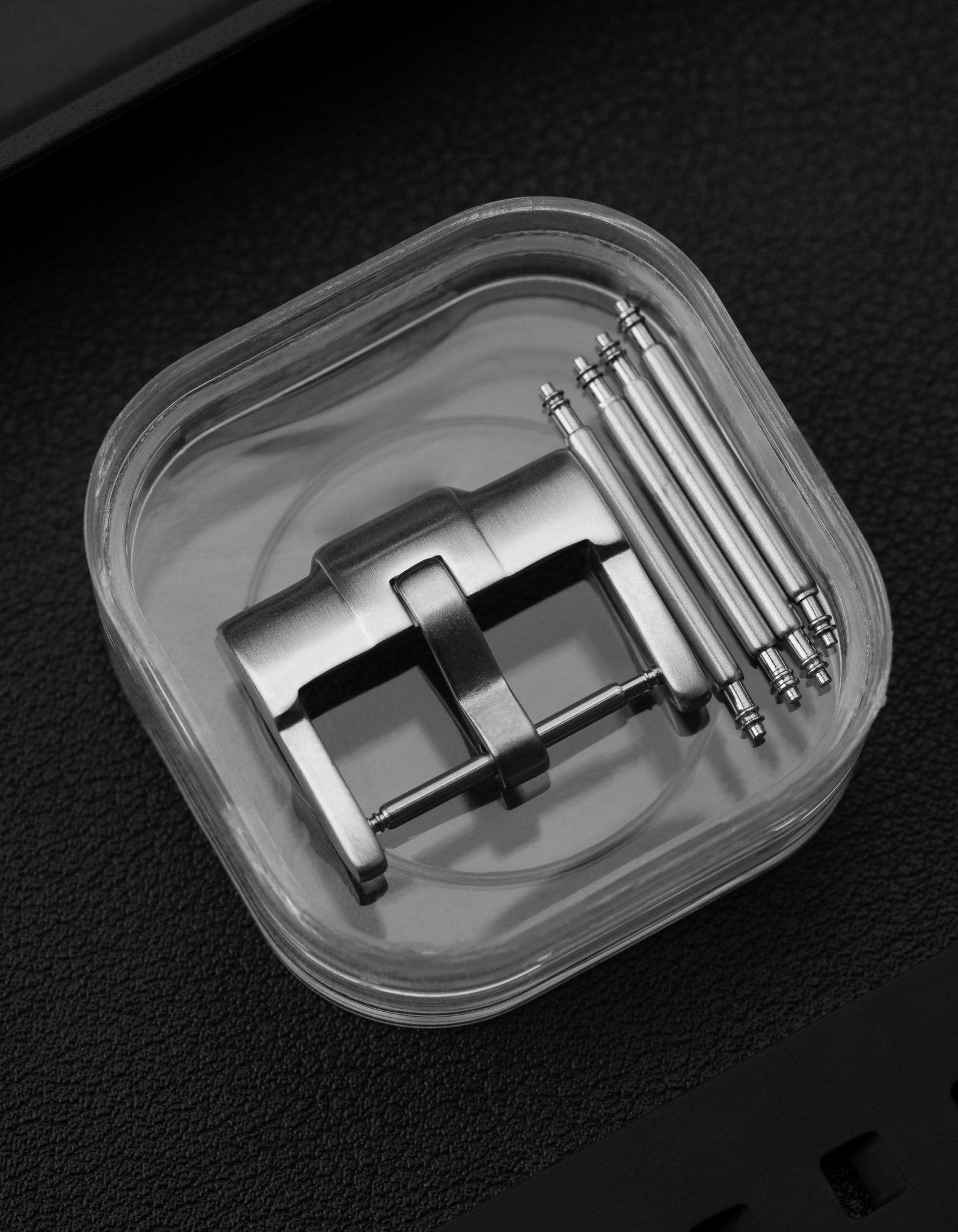 Standard silver buckle for watch straps with included spring bars in plastic case