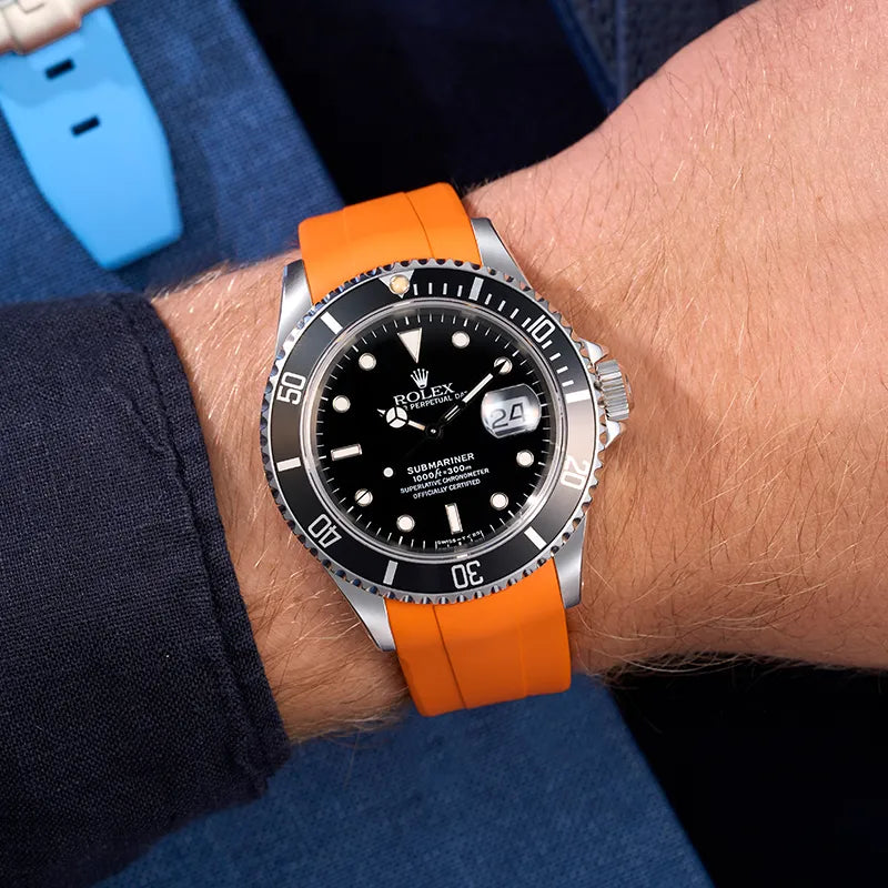 Rolex Submariner with an orange rubber strap, specially designed for a perfect fit and durability, available at Wristbuddys.