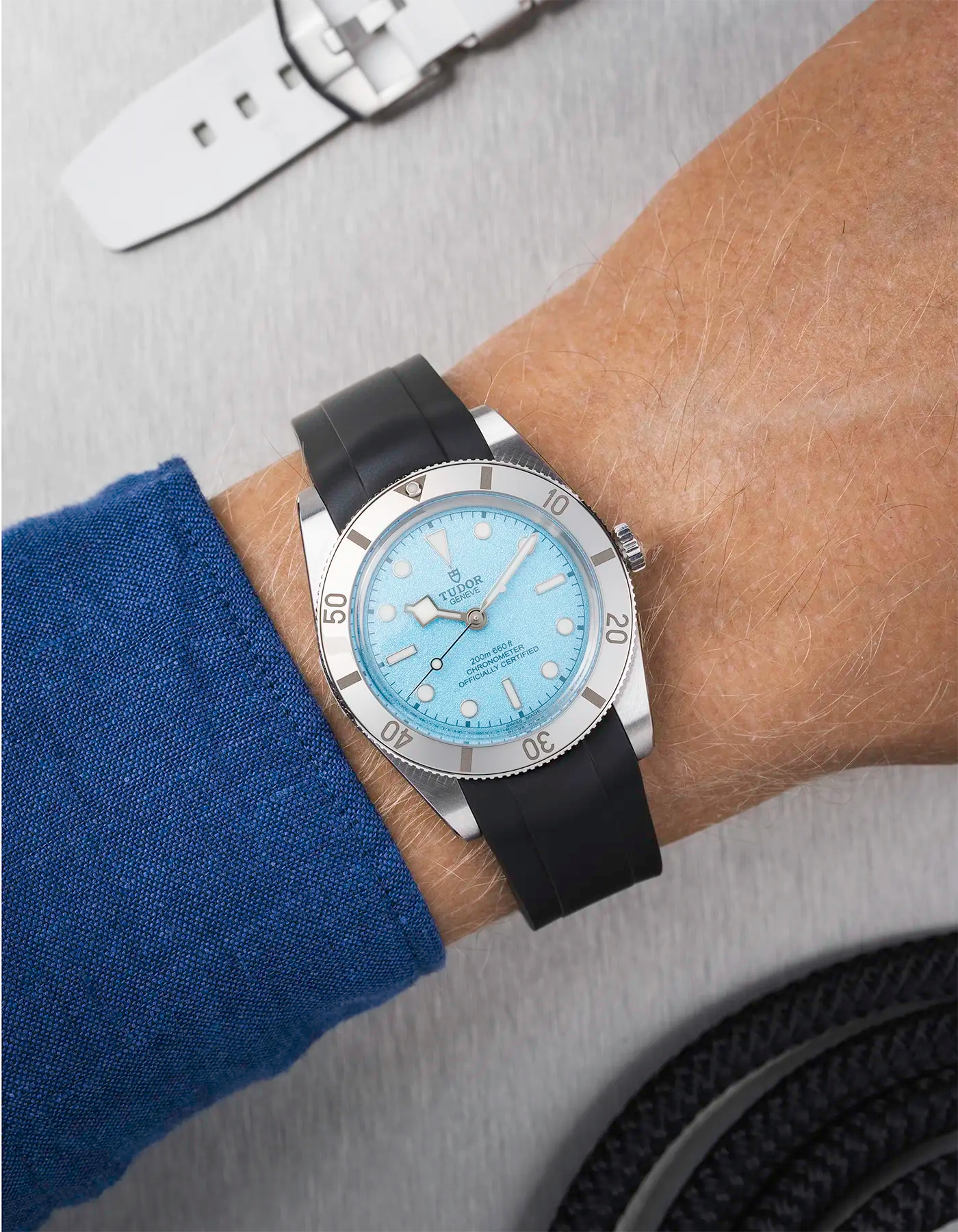 Tudor Black Bay 54 Blue Lagoon on wrist with black FKM rubber strap and black PVD buckle