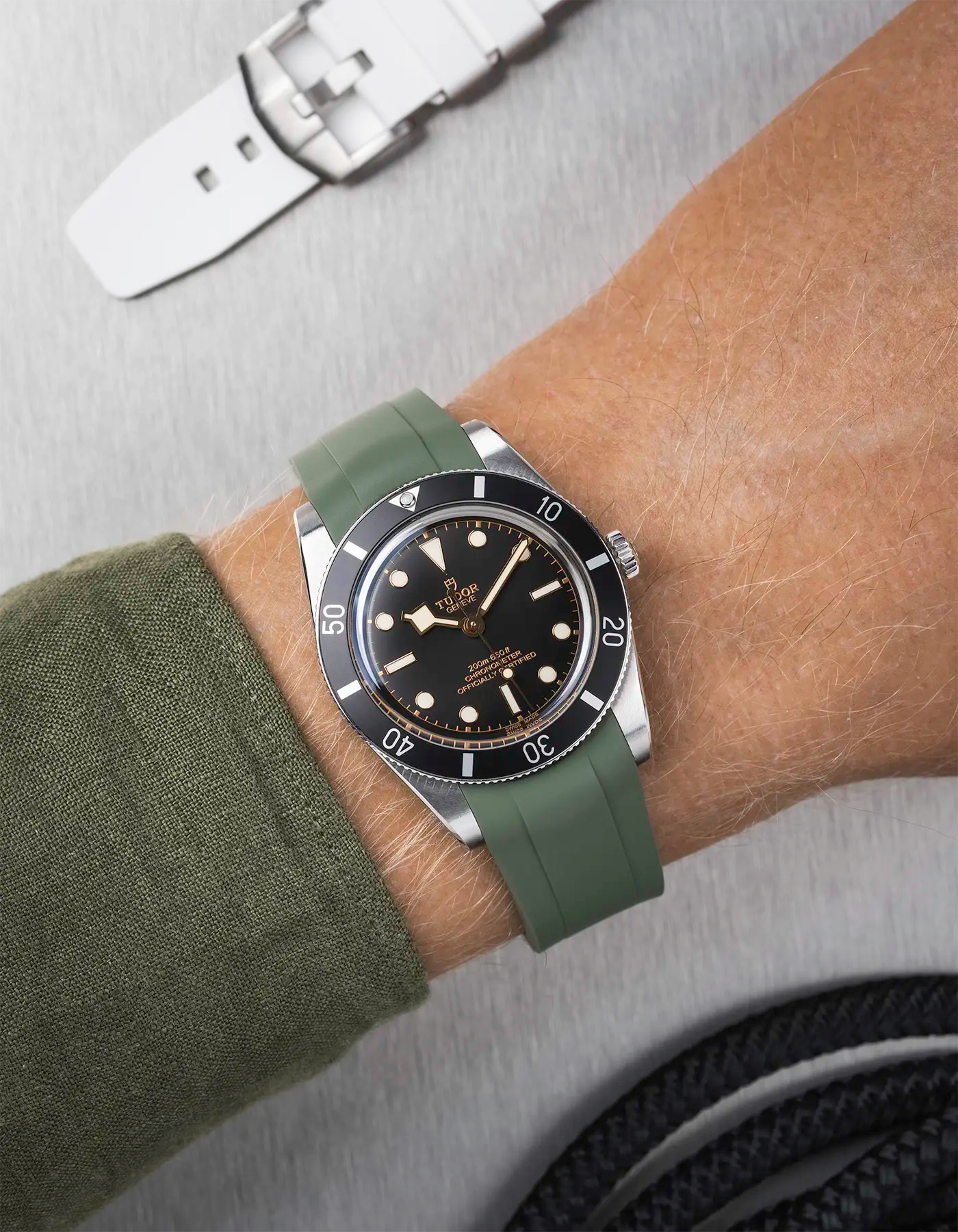 Tudor Black Bay 54 on wrist with dark green FKM rubber strap and stainless steel buckle