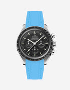 Black Omega Speedmaster watch with a capri blue vertech rubber watch strap from Wristbudyss and a detailed face on a white background