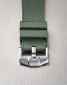 Macro view of green Vertech FKM rubber strap buckle and textured keeper detail