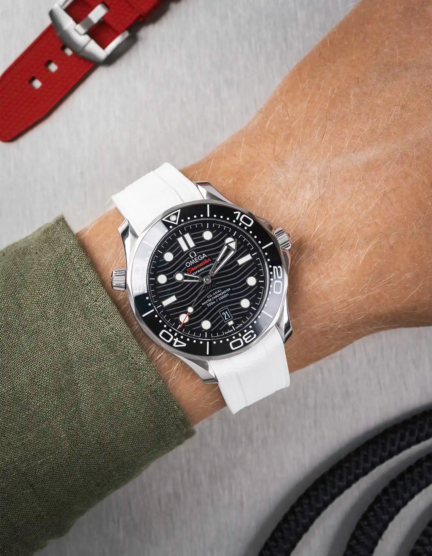 Omega Seamaster 300 Diver with black dial on wrist, paired with white Vertech FKM rubber strap