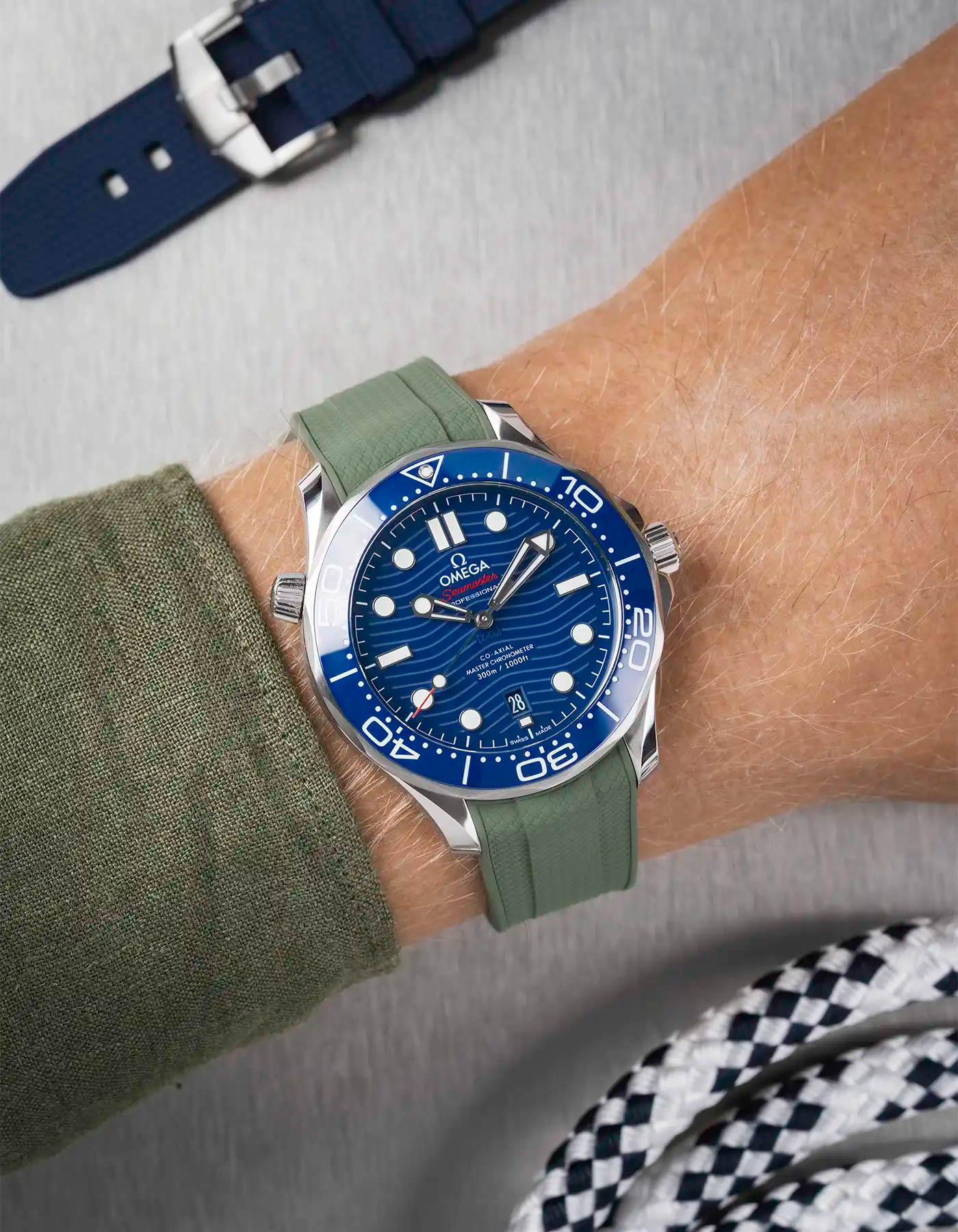 Omega Seamaster 300 Diver with blue dial on wrist, paired with dark green Vertech FKM rubber strap