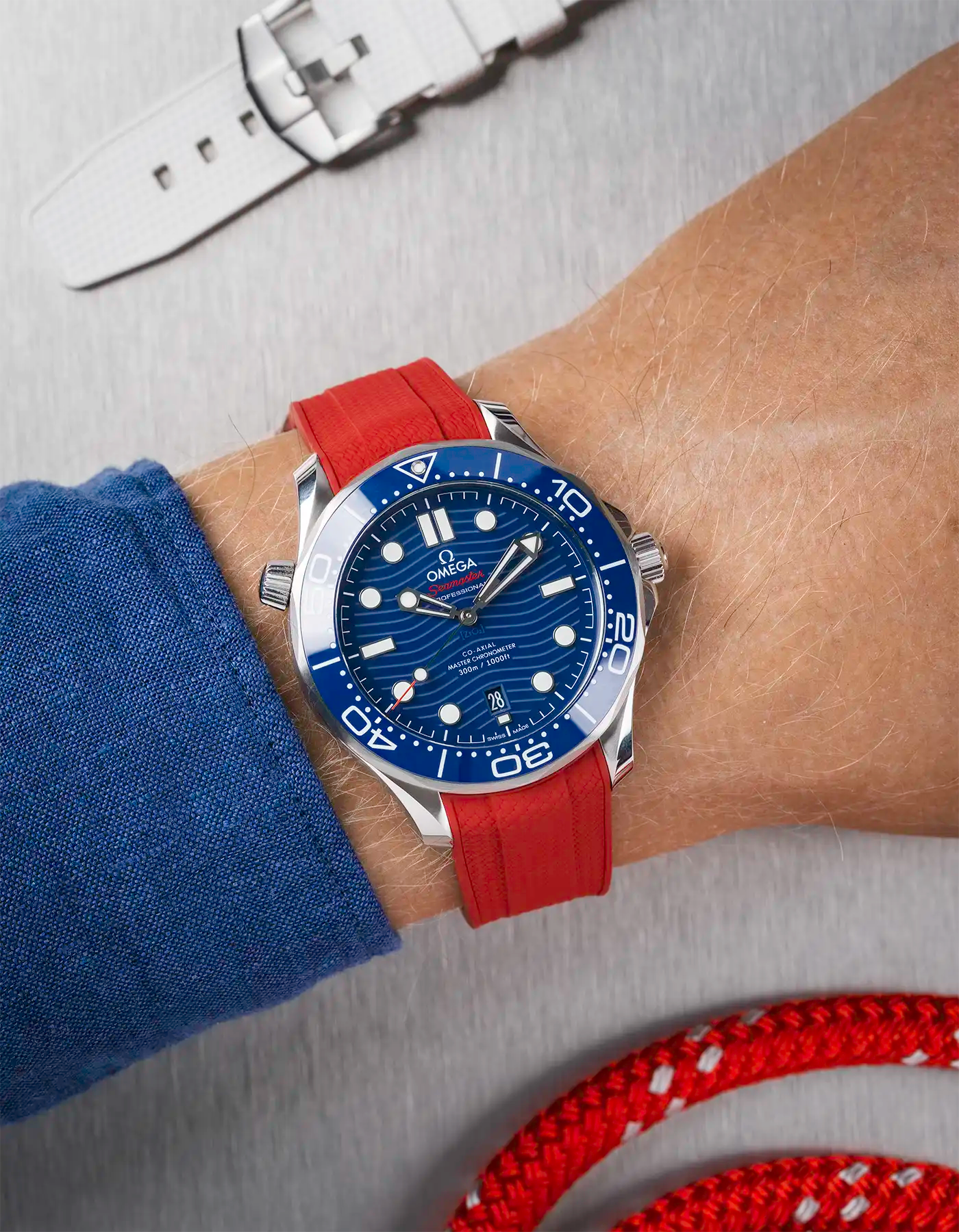 Omega Seamaster 300 Diver with blue dial on wrist, paired with red Vertech FKM rubber strap
