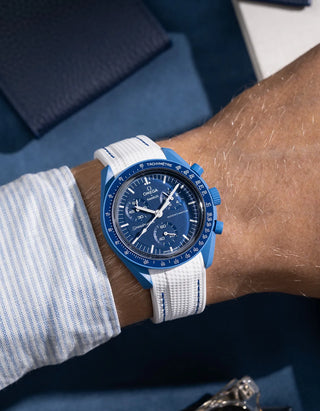 White curved rubber strap with blue stitching for Omega MoonSwatch, shown on wrist with Vertech textured finish
