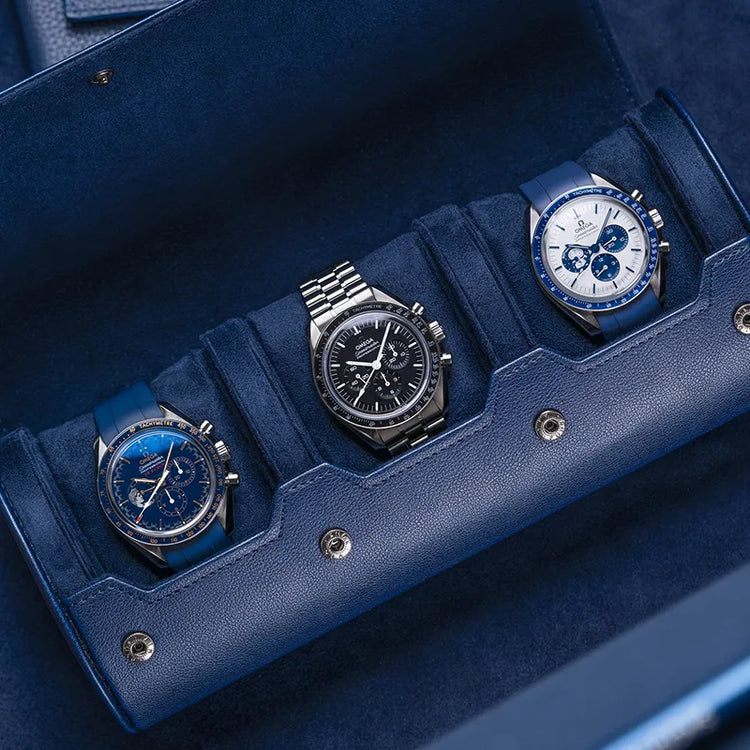Navy blue 3-slot watch roll displaying luxury timepieces, showcasing the elegant design and practical protection of Wristbuddys watch rolls.