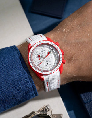 Wrist shot showing white rubber strap with red stitching for Omega X Swatch MoonSwatch Mission to Mars